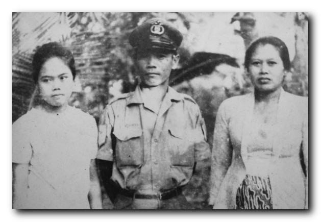 Sri and her parents, her father in his police officer's uniform / Supplied